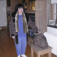 Dolores Rinaldi stands next to a 380 lb Canyon Diablo meteorite