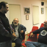 Scott Tracey, Dave Rose, and Rick Lynch relaxing in the clubhouse