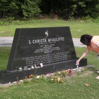 Dolores Rinaldi places a cross at the grave of teacher/astronaut Christa McAuliffe