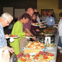 Guests make their way through the buffet at the Saturday evening program