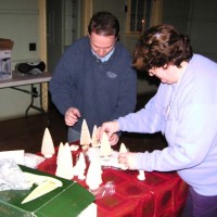 Ted Ferneza and Tina Huestis set up for the December 2005 Meeting & Holiday Party