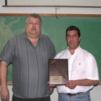 Incoming president Dave Huestis presents outgoing president Dan Lorraine with an award for his servi