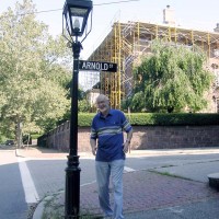 Trustee Rick Arnold under the Arnold Street sign