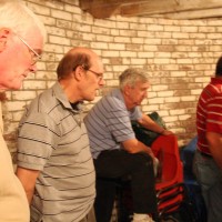 Skyscrapers members look on as Al Hall opens the original Clark telescope crate